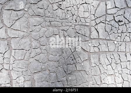 cracked earth cracked or old ruberoid texture. Stock Photo