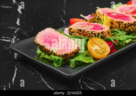 Grilled tuna steak in sesame breading with vegetables Stock Photo
