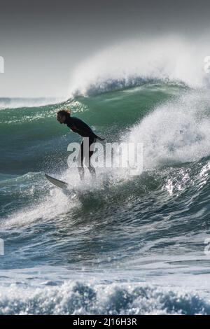 Surfing action and big waves at Fistral in Newquay in Cornwall in the UK. Stock Photo