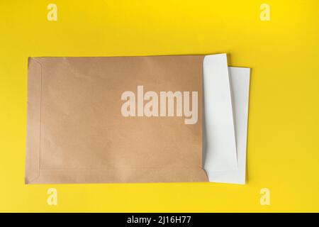 a brown paper envelope containing a few white sheets of paper Stock Photo