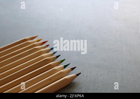 Color pencils background. Selective focus image of color pencils on concrete floor with copy space. Stock Photo
