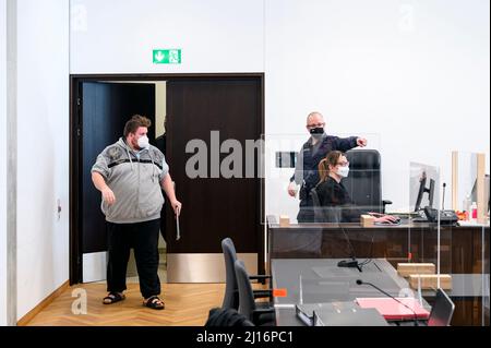 Nuremberg, Germany. 23rd Mar, 2022. r Drachenlord (l) enters the  hearing room. The appeal hearing is taking place at the Nuremberg Criminal  Justice Center. In October, the district court had sentenced the blogger to  two years in prison without