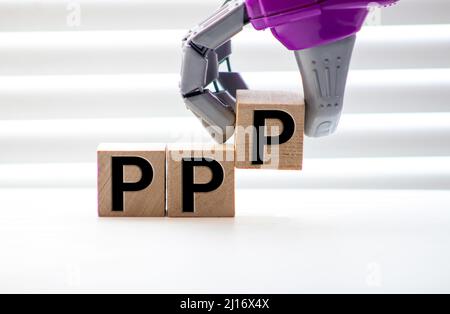 Pile with three wooden cubes - letters PPP meaning Praise Picture Push on them, space for more text, images at right side. Stock Photo
