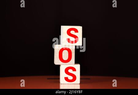 Wooden blocks forming the letters SOS isolated on white background Stock Photo