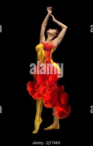 Portrait of young beautiful woman covered with red and yellow paint posing isolated over black background Stock Photo
