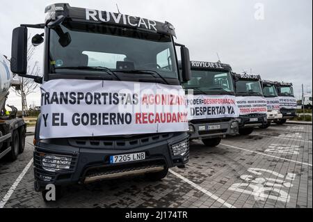 Madrid, Spain. 23rd Mar, 2022. Trucks are seen parked during the tenth day of a national transportation strike. Truck drivers are protesting against their precarious working conditions as well as against the increase in fuel prices, accentuated by the Russian invasion of Ukraine. Truckers gathered with more than 600 trucks and concrete mixers and will maintain an indefinite strike until they reach an agreement with the government. Credit: Marcos del Mazo/Alamy Live News Stock Photo