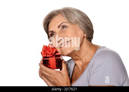 Portrait of smiling senior woman posing with present Stock Photo