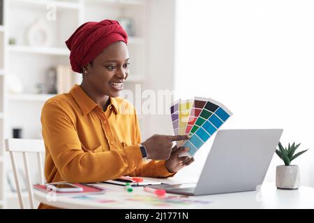 Stylish young black woman independent contractor having video conference Stock Photo