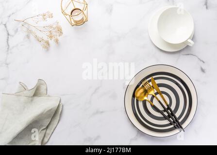 Image of cutlery sets with plate, cup and candle. Party theme, place and table setting. Stock Photo