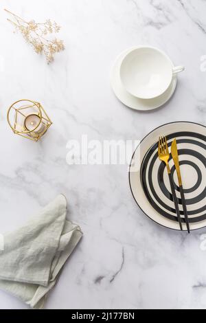 Image of cutlery sets with plate, cup and candle. Party theme, place and table setting. Stock Photo