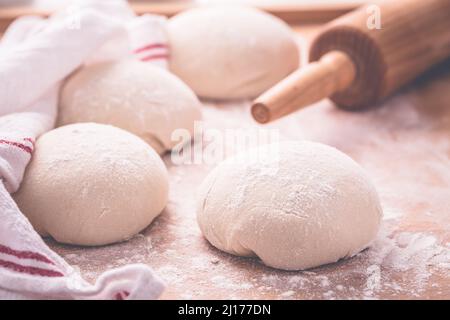 Yeast dough for making braided cakes, pies, pizza and rolls with rolling pin. Preparing leavened dough Stock Photo