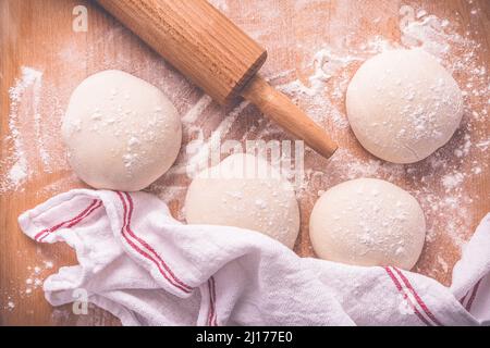 Yeast dough for making braided cakes, pies, pizza and rolls with rolling pin. Preparing leavened dough Stock Photo