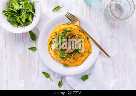 Italian cuisine - spinach and feta cheese fritatta. Egg based omelette or quiche. Stock Photo