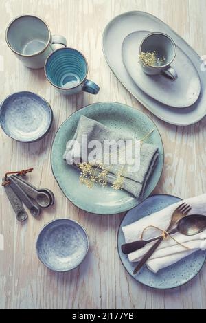 Stoneware kitchen utensils - sustainability. Assortment of plates, bowls and cups from natural materials. Stock Photo
