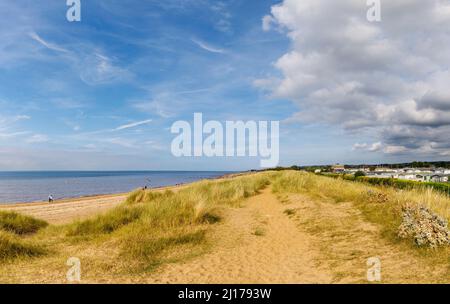 Sandy dunes on the beach at Heacham, a coastal village in west Norfolk, England, overlooking The Wash, and mobile home holiday caravan park Stock Photo