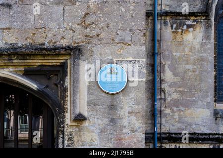 Blue plaque on the wall of 15th century St Peter's church commemorating the ordination of Thomas Wolsey in 1498, High Street, Marlborough, Wiltshire Stock Photo