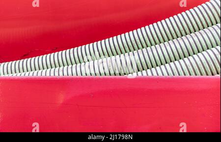 ribbed hoses in a red background Stock Photo