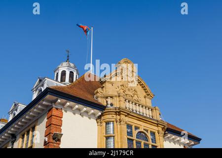 Detail of the front with coat of arms of grade II listed Marlborough Town Hall, a focal point in High Street, Marlborough, a town in Wiltshire Stock Photo