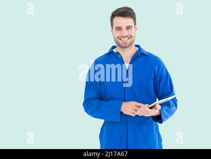 Portrait of caucasian male worker holding digital tablet against copy space on green background Stock Photo