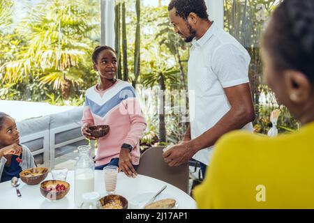 Daughter talking with father at breakfast table Stock Photo