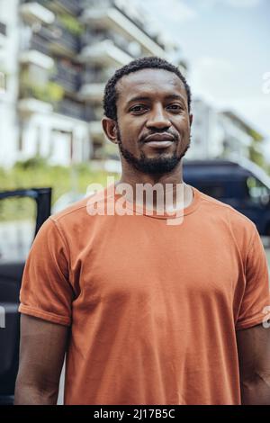 Confident man wearing orange t-shirt Stock Photo