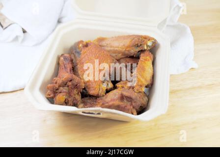 Finger Food - Deep Fried Chicken Wings in a Takeout Container Stock Photo