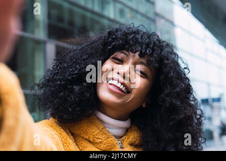 Cheerful young woman taking selfie Stock Photo