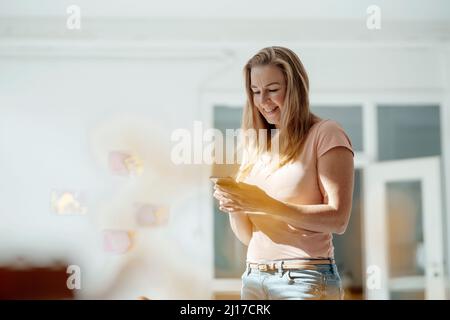 Smiling woman using mobile phone Stock Photo