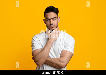 Doubting middle eastern guy looking at camera Stock Photo