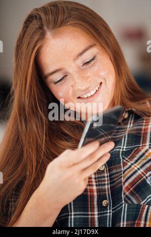 Smiling woman using mobile phone Stock Photo