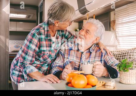 Smiling senior couple looking at each other in motor home Stock Photo