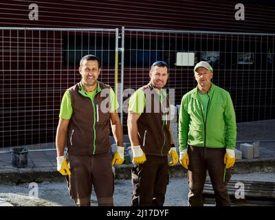 Construction workers standing together at site Stock Photo
