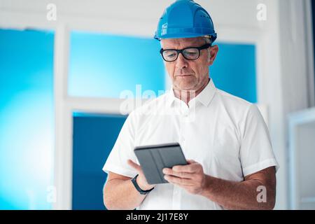 Construction worker using tablet computer Stock Photo