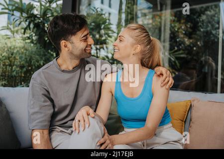 Happy couple talking at patio Stock Photo