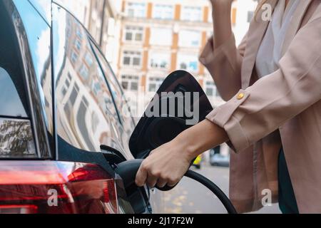 Woman refueling car at gas station Stock Photo