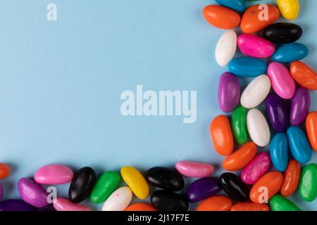 Overhead view of colorful candies and copy space on blue background Stock Photo