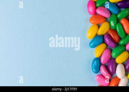 Overhead view of sweet multi colored candies on blue background with copy space Stock Photo