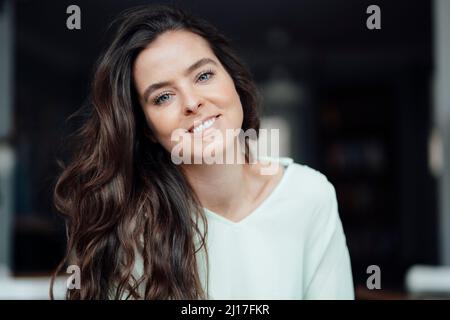 Smiling brunette woman in cafe Stock Photo