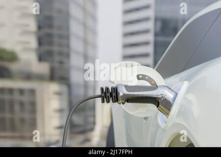 Three dimensional car with electric plug at charging station Stock Photo