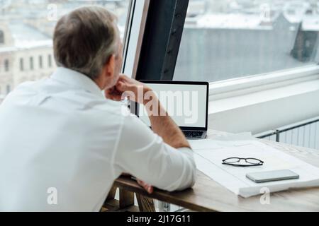 Businessman using laptop at work place Stock Photo