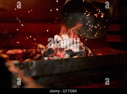 Theres nothing like the smell of a charcoal grill being fired up. Closeup shot of charcoal burning in a fireplace. Stock Photo