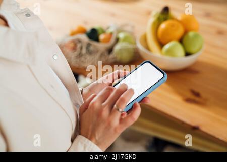 Woman text messaging through smart phone Stock Photo