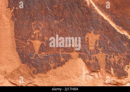 The Moab Man Panel is a large Fremont Culture Native American rock art panel in Mill Creek Canyon near Moab, Utah.  These petroglyphs are  800  to 100 Stock Photo