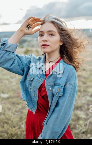 Free Photos - A Beautiful, Curvy Woman Wearing A Denim Jacket And Posing In  Front Of A Large Rack Of Clothing, Which Includes Various Dresses Hanging  On A Wall. The Woman Is