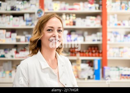 Smiling female pharmacist at pharmacy store Stock Photo
