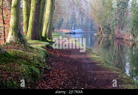 PhotographTrent and Mersey canal a British Waterways canal near Shugborough in Staffordshire showing with towpath and light forms of nature mirrored o Stock Photo