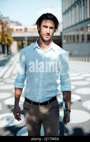 Handsome businessman with tablet PC at office park on sunny day Stock Photo