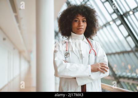 Confident doctor with arms crossed in hospital Stock Photo