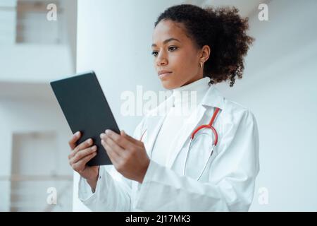 Healthcare worker using tablet PC at hospital Stock Photo
