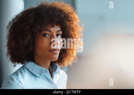 Confident working woman at work place Stock Photo